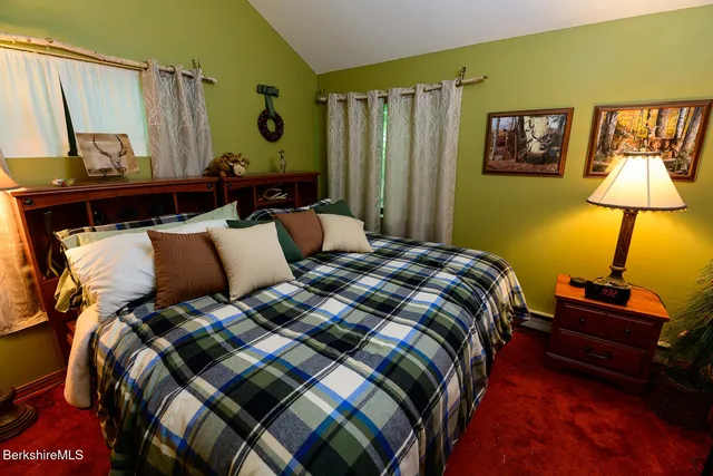 a bedroom with a bed and a lamp