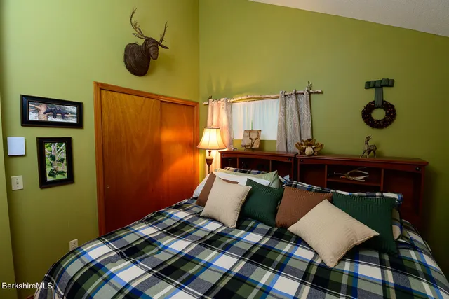 a bedroom with a bed and cabinets