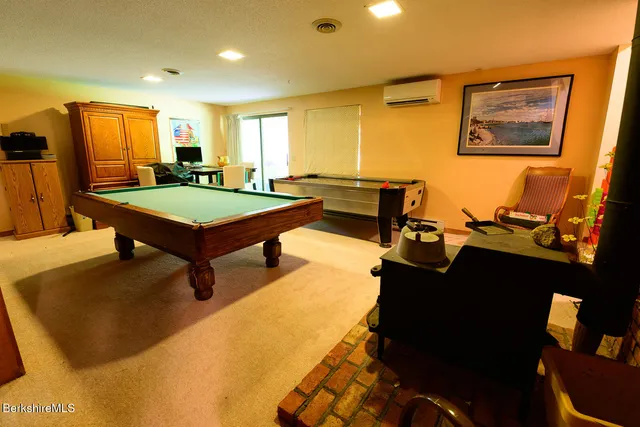 a room with pool table and windows