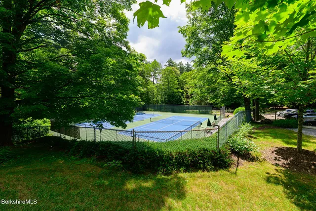 a view of backyard with seating area and trees in the background