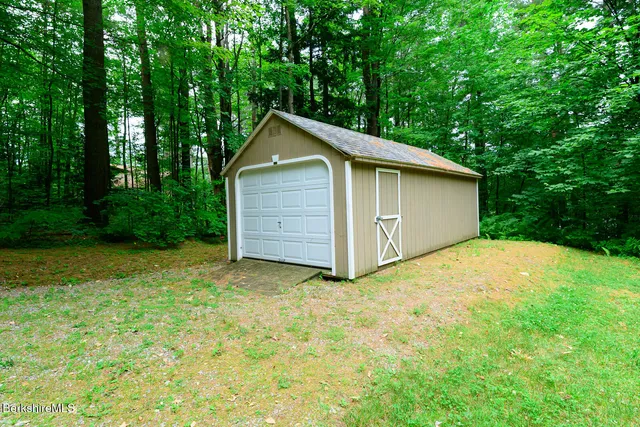 a view of backyard of house with green space