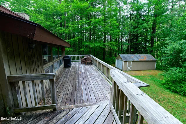 a balcony with wooden floor and outdoor space