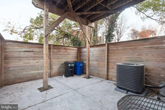 a view of a house with backyard and wooden fence