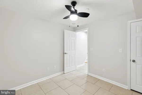 an empty room with fan and windows