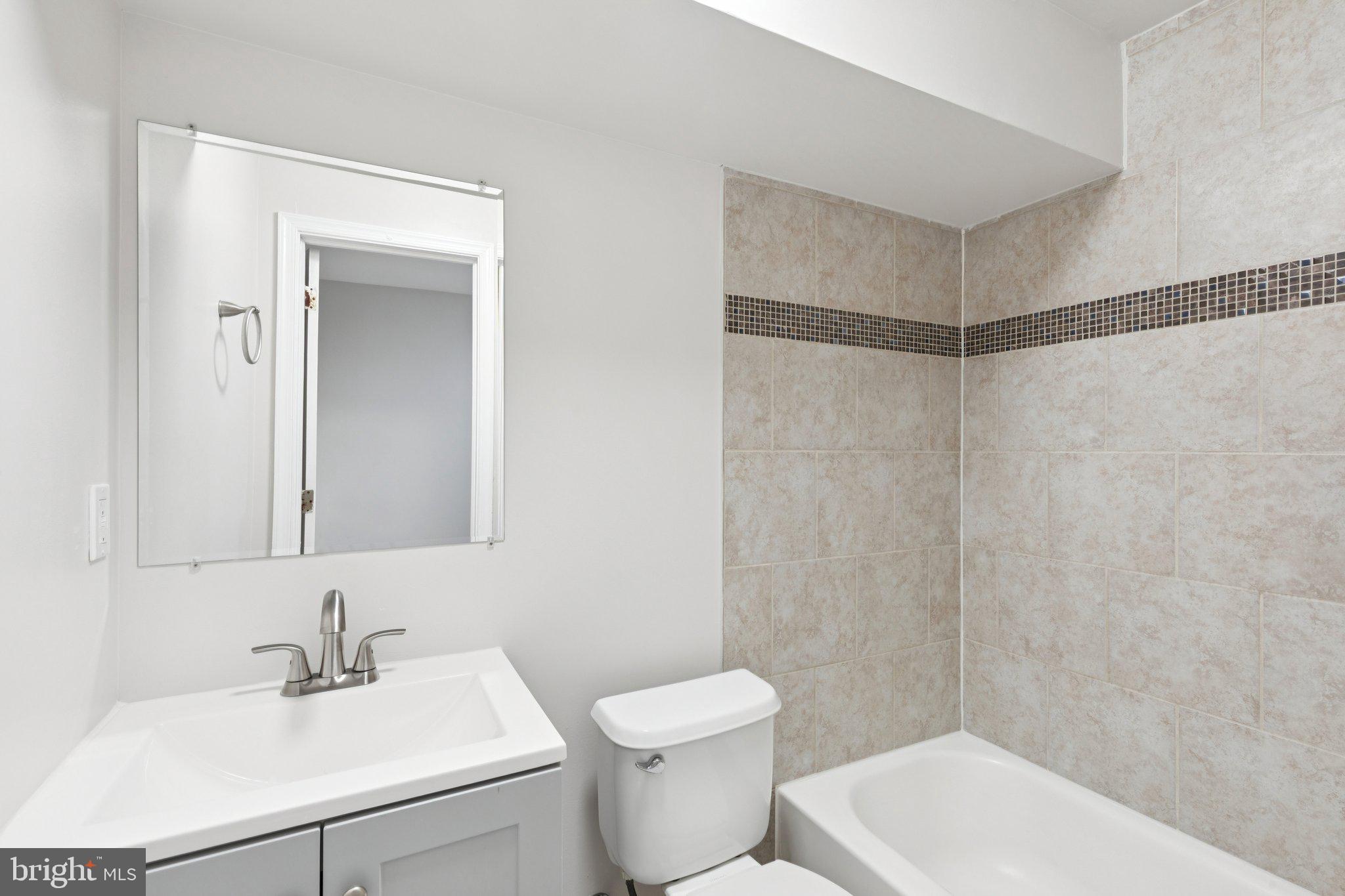 1931 North Uber Street, Unit 1 Philadelphia, PA 19121 - Photo 22 of 26 a bathroom with a sink toilet and shower