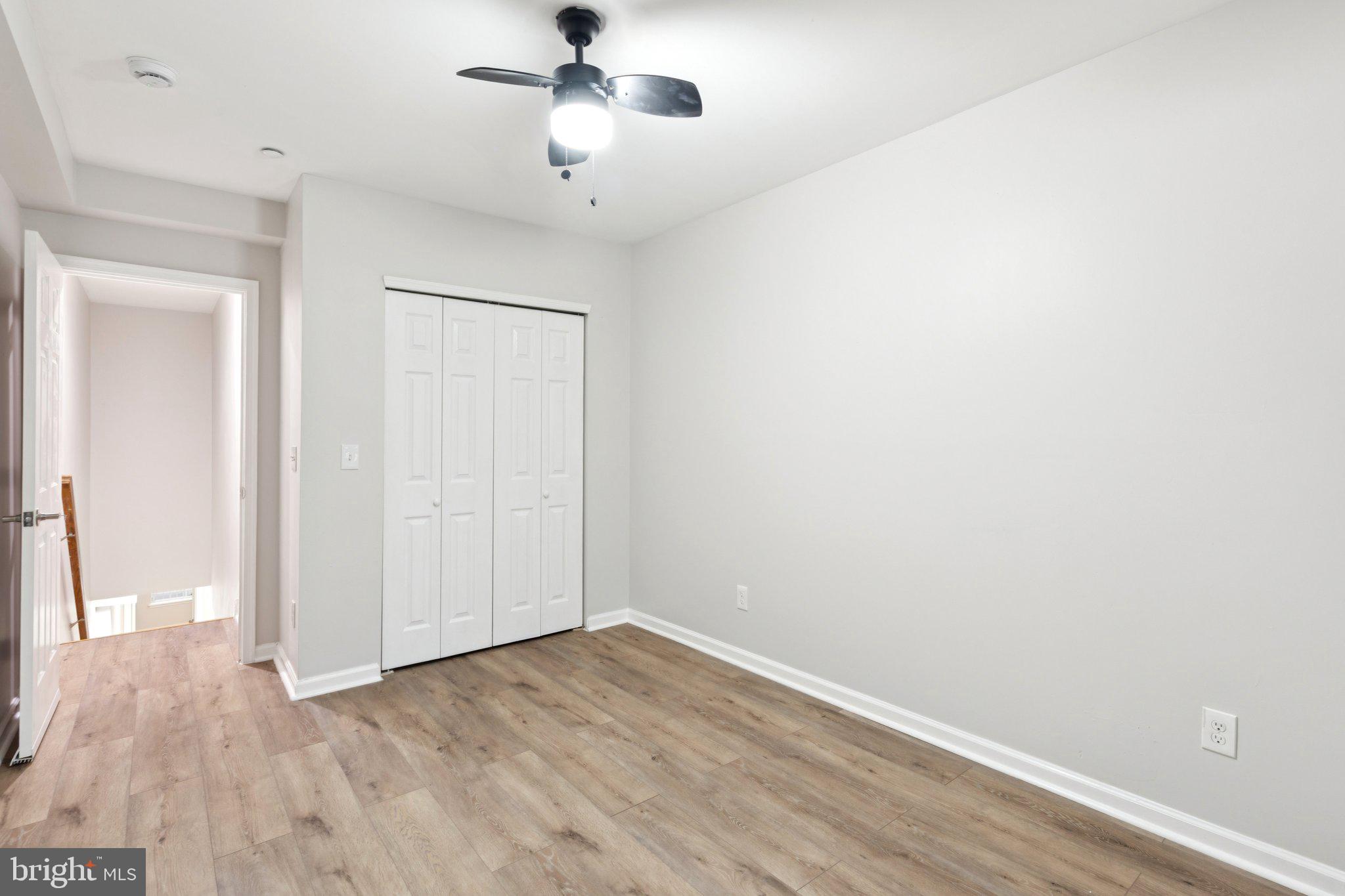 1931 North Uber Street, Unit 1 Philadelphia, PA 19121 - Photo 24 of 26 an empty room with wooden floor fan and windows