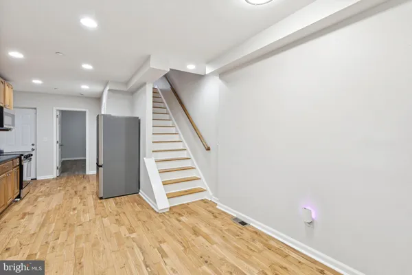 a kitchen with stainless steel appliances granite countertop a refrigerator and a sink