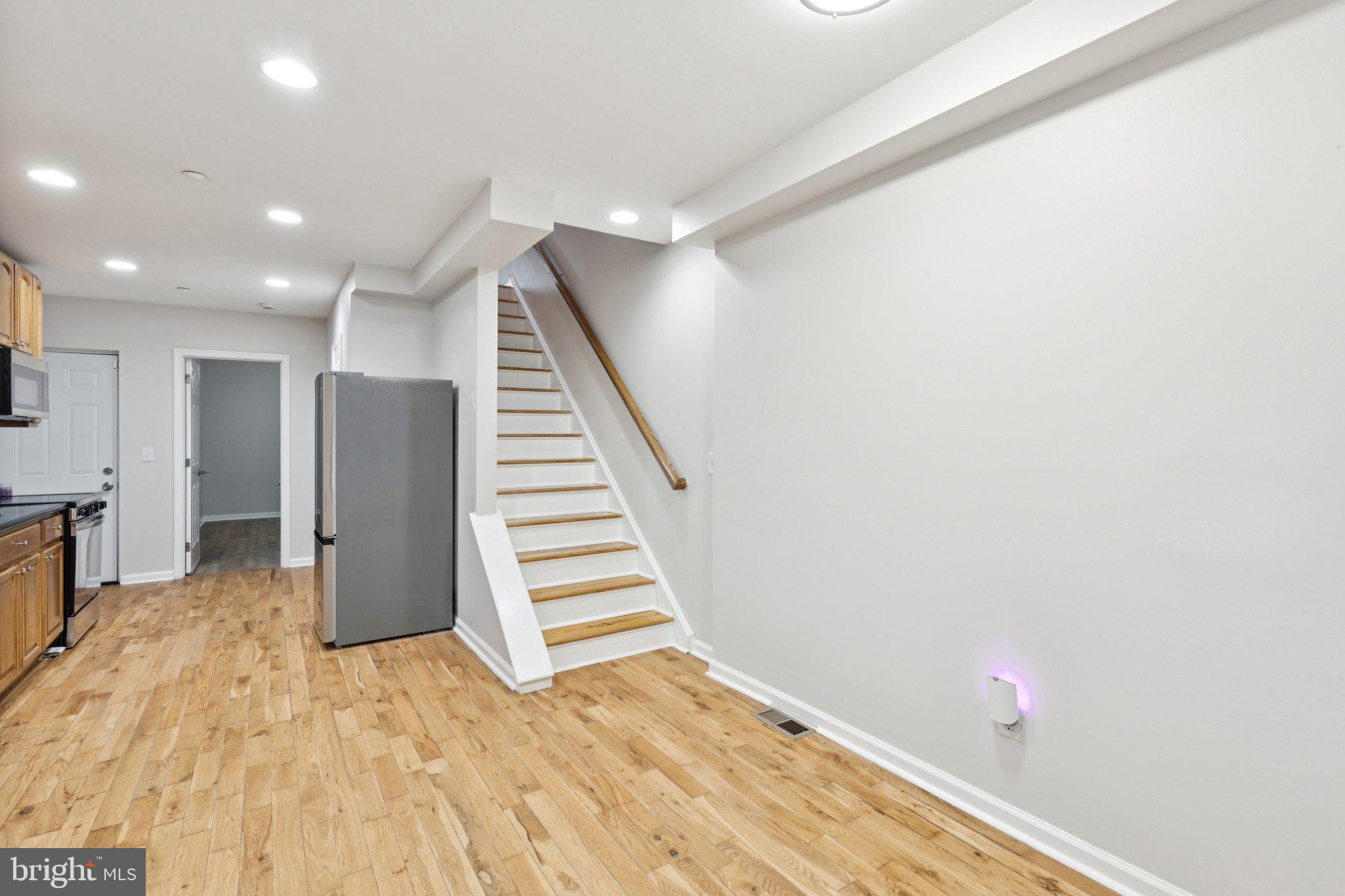 1931 North Uber Street, Unit 1 Philadelphia, PA 19121 - Photo 3 of 26 a view of a kitchen with wooden floor and staircase
