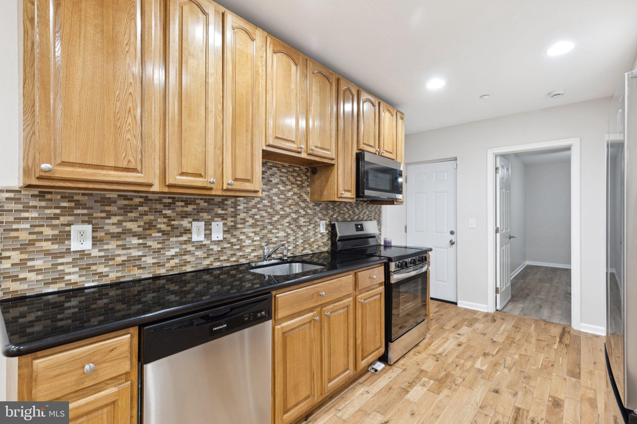 1931 North Uber Street, Unit 1 Philadelphia, PA 19121 - Photo 6 of 26 a kitchen with stainless steel appliances granite countertop a stove a sink and a granite counter tops