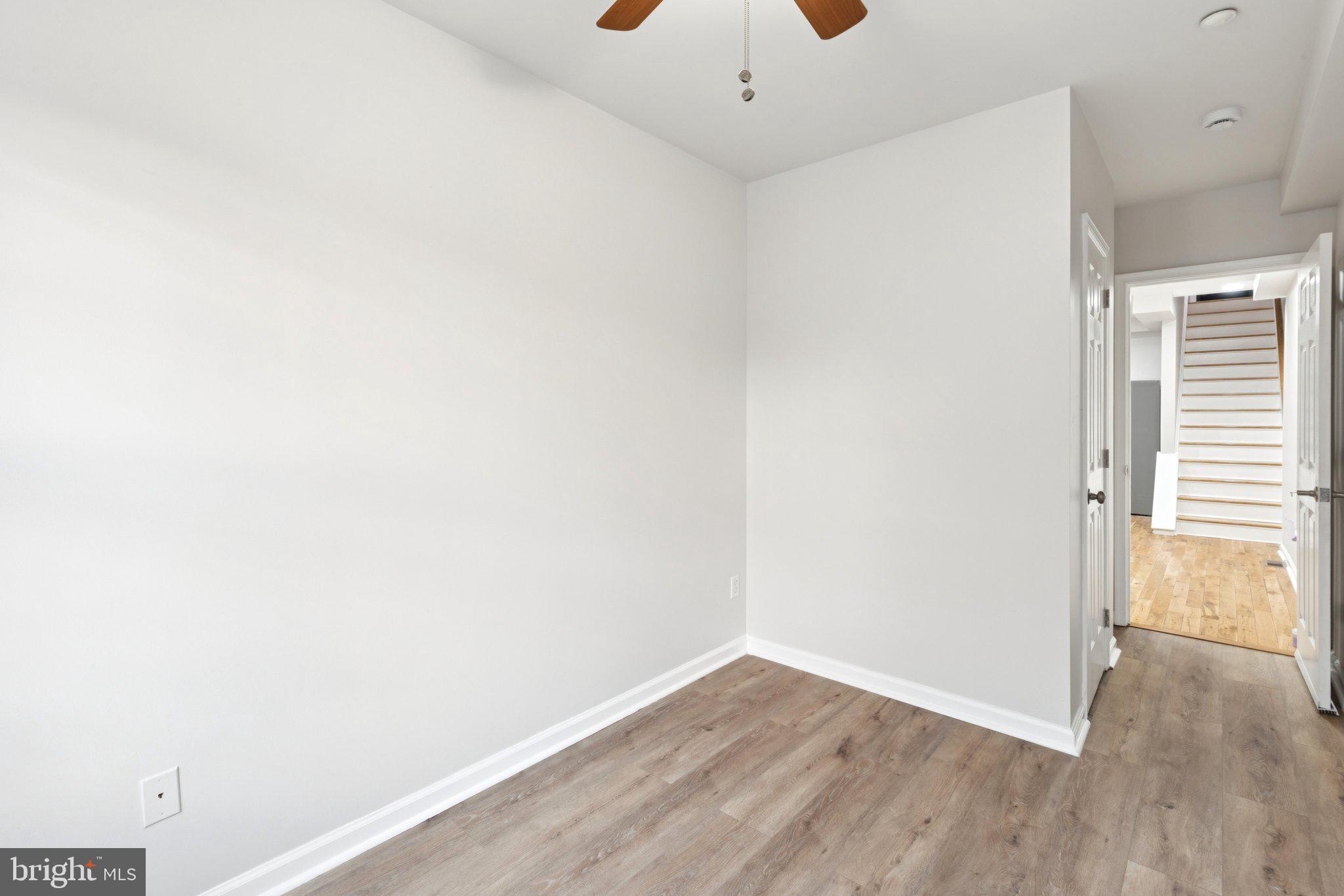 1931 North Uber Street, Unit 1 Philadelphia, PA 19121 - Photo 7 of 26 an empty room with wooden floor and windows