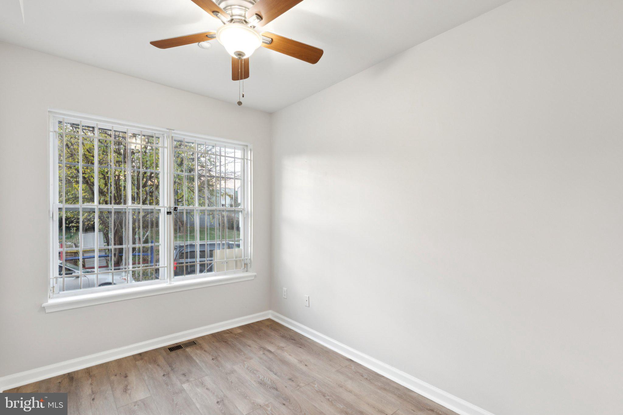 1931 North Uber Street, Unit 1 Philadelphia, PA 19121 - Photo 8 of 26 wooden floor in an empty room with a window
