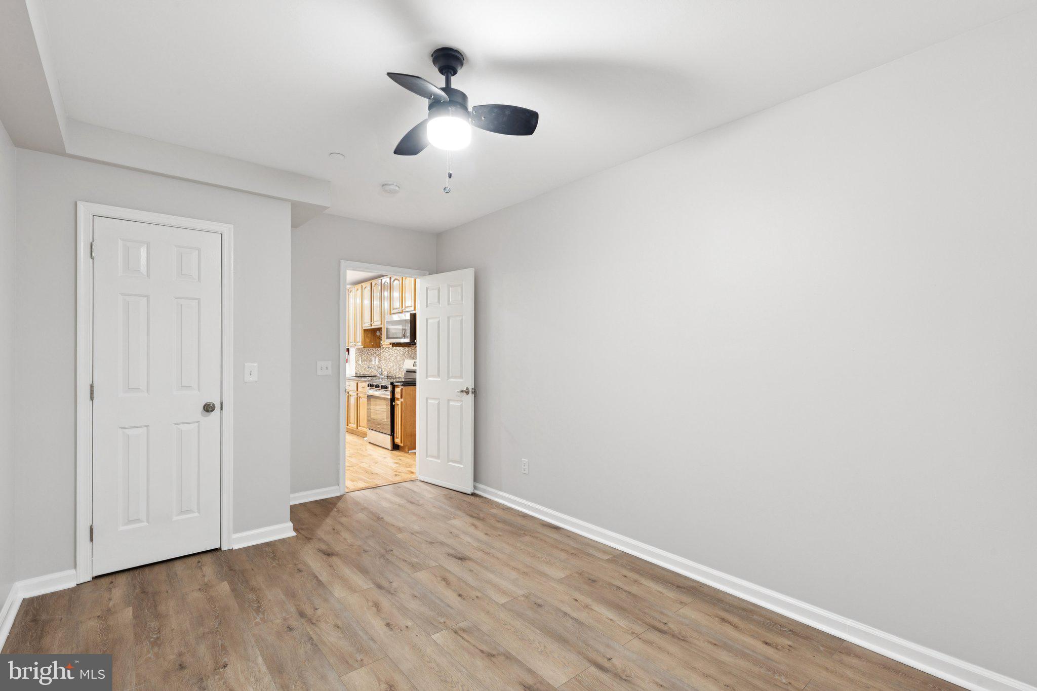 1931 North Uber Street, Unit 1 Philadelphia, PA 19121 - Photo 10 of 26 an empty room with wooden floor and windows