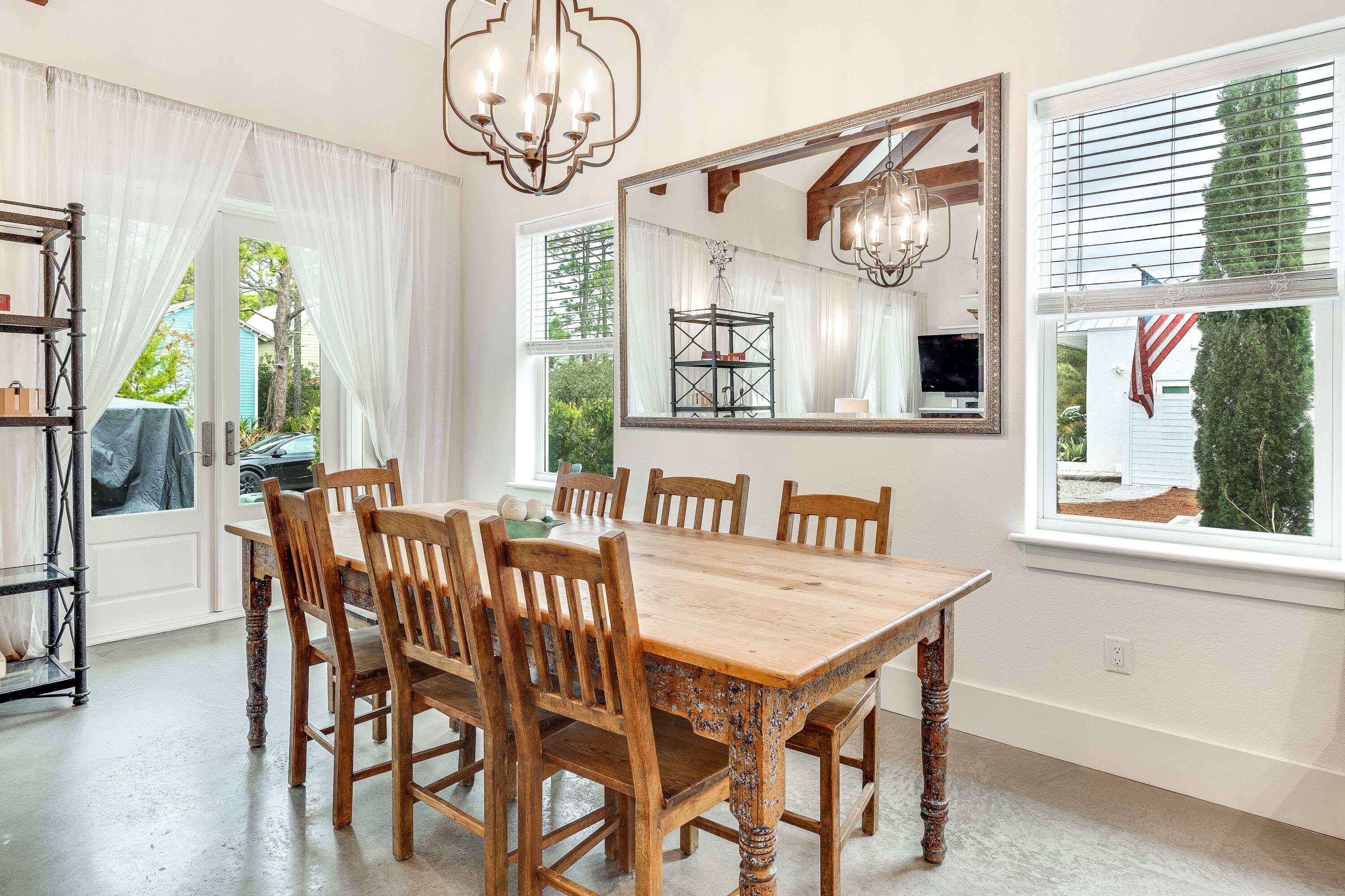 75 Barcelona Avenue Santa Rosa Beach, FL 32459 - Photo 12 of 41 a view of a dining room with furniture window and wooden floor
