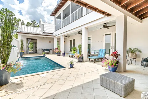 a view of living room with patio furniture and potted plants