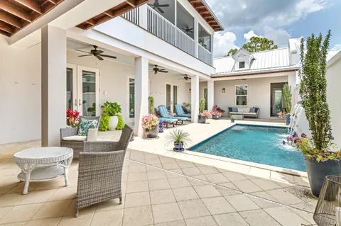 a view of a patio with couches table and chairs and potted plants