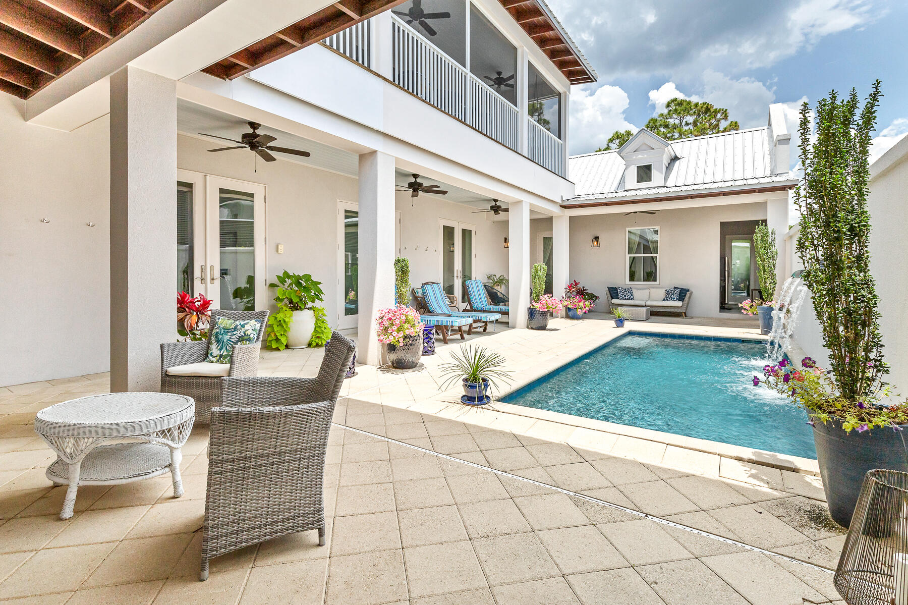 75 Barcelona Avenue Santa Rosa Beach, FL 32459 - Photo 14 of 41 a view of a patio with couches table and chairs and potted plants