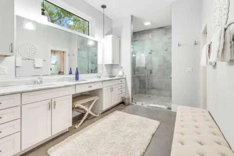a spacious bathroom with a shower sink and mirror
