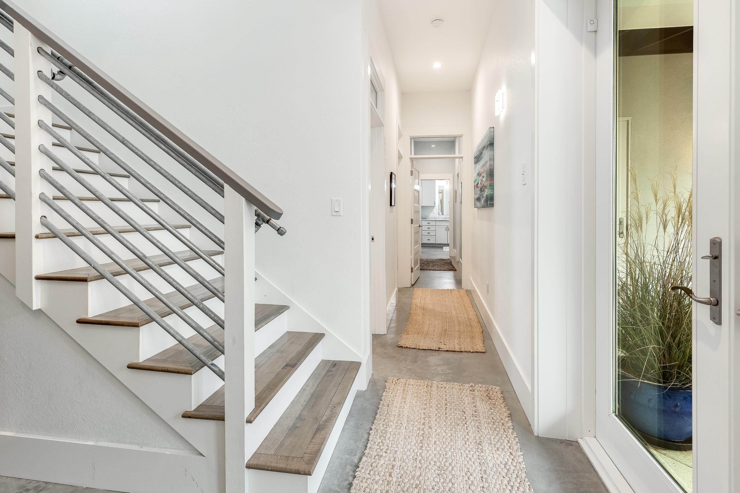 75 Barcelona Avenue Santa Rosa Beach, FL 32459 - Photo 18 of 41 a view of a hallway with wooden floor and staircase