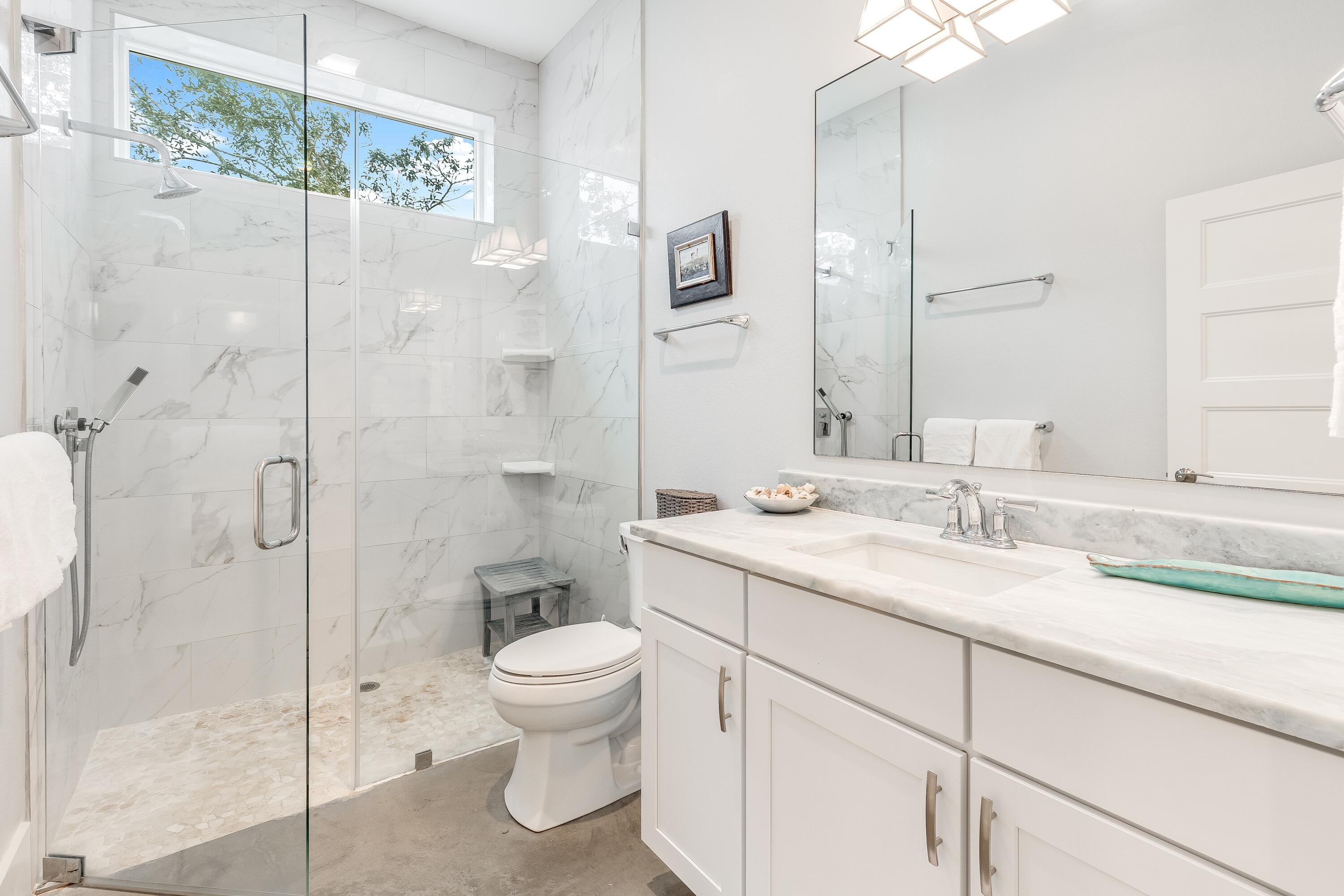 75 Barcelona Avenue Santa Rosa Beach, FL 32459 - Photo 20 of 41 a bathroom with a granite countertop sink a toilet and shower