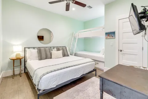 a bedroom with a bed and a flat tv screen