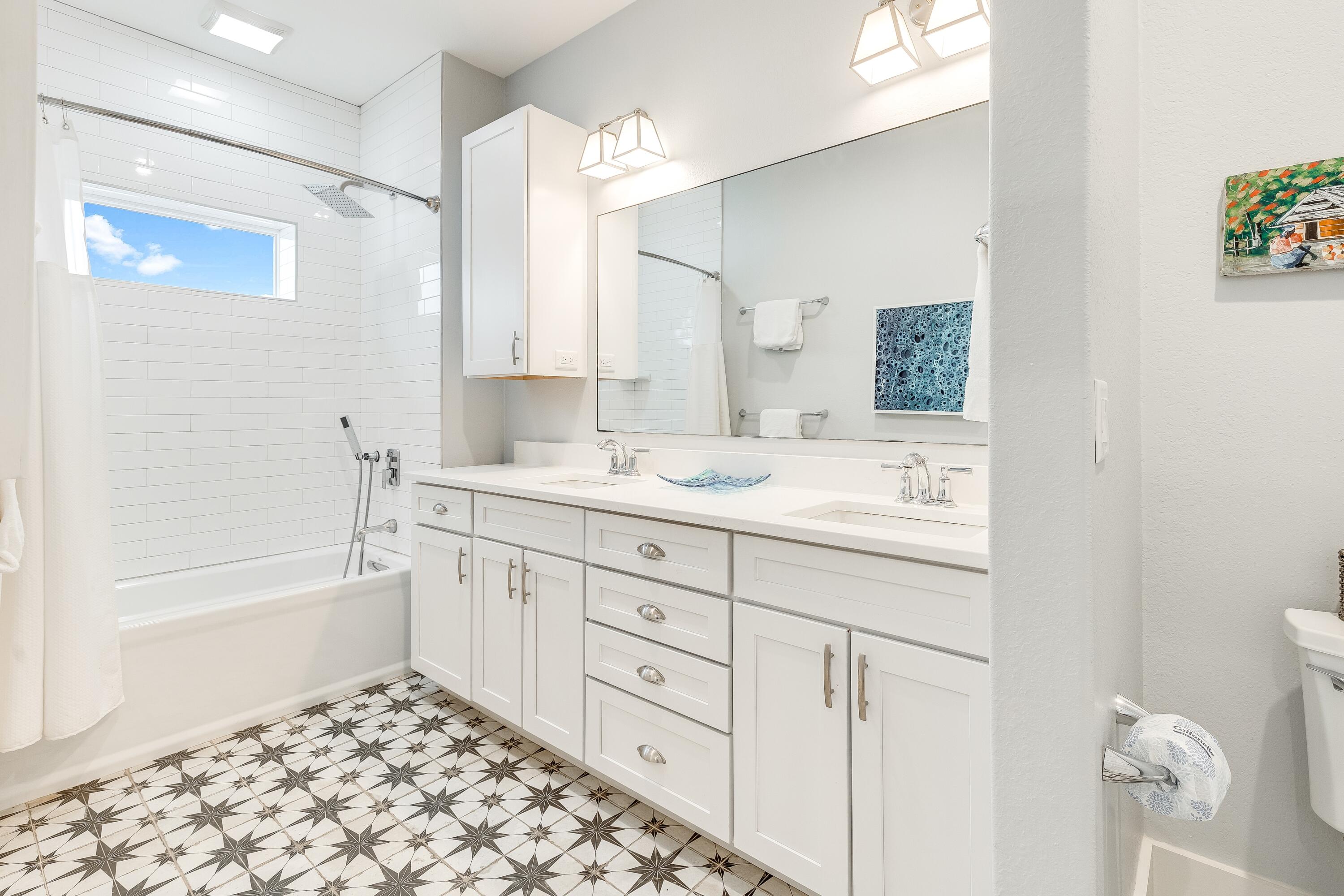 75 Barcelona Avenue Santa Rosa Beach, FL 32459 - Photo 24 of 41 a bathroom with a double vanity sink a mirror a bathtub and next to a window