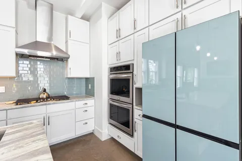 a kitchen with stainless steel appliances a refrigerator sink and cabinets