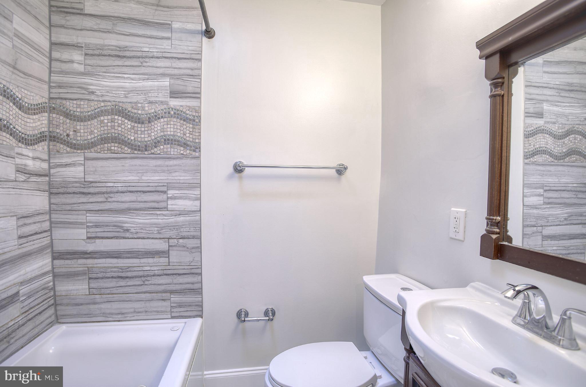 1029 Stamford Road Baltimore, MD 21229 - Photo 13 of 17 a bathroom with a sink and a toilet