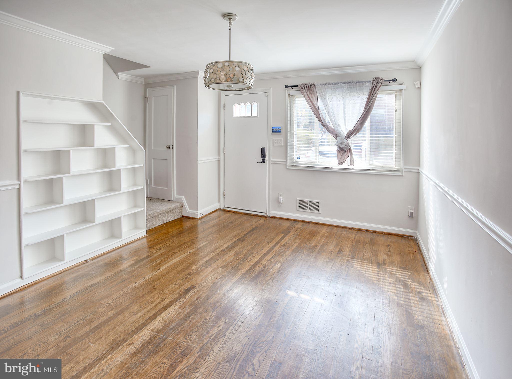 1029 Stamford Road Baltimore, MD 21229 - Photo 4 of 17 wooden floor in an empty room with a window