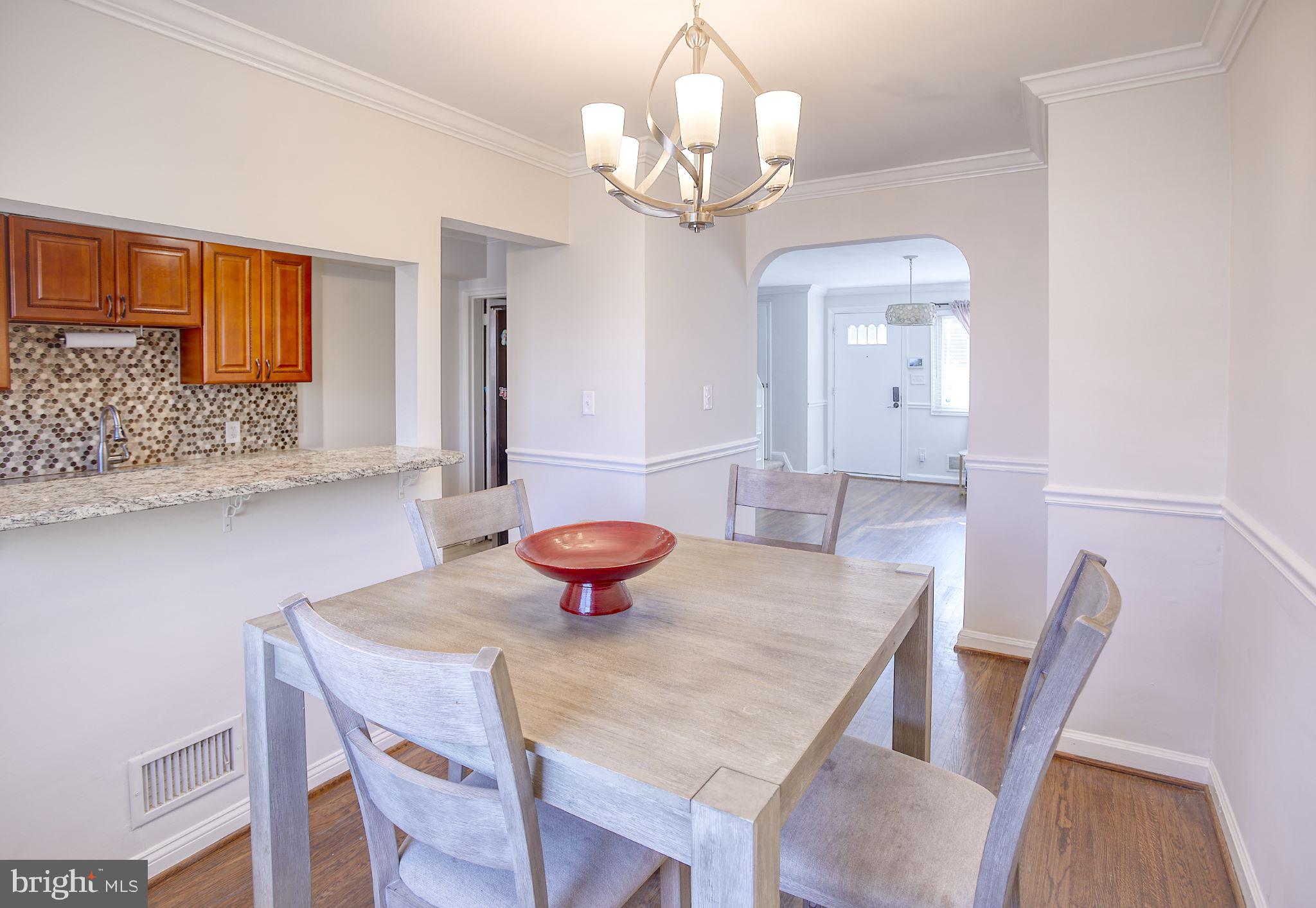 1029 Stamford Road Baltimore, MD 21229 - Photo 8 of 17 a view of a dining room with furniture and wooden floor