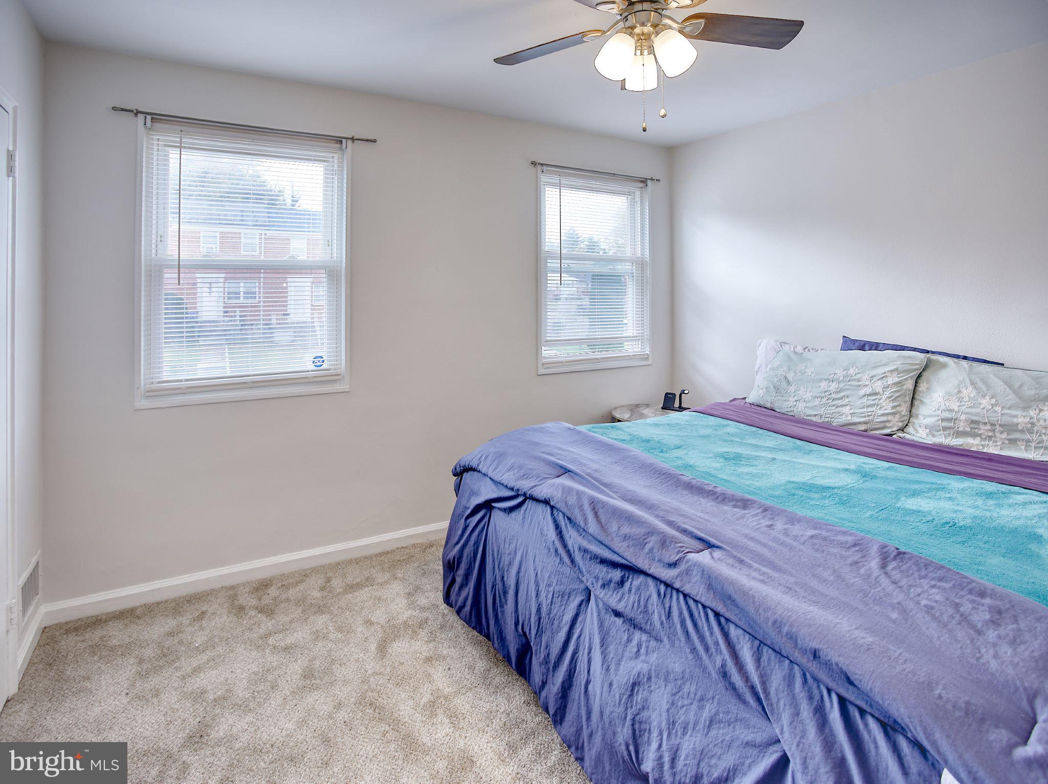 1029 Stamford Road Baltimore, MD 21229 - Photo 9 of 17 a bedroom with a bed and a chandelier