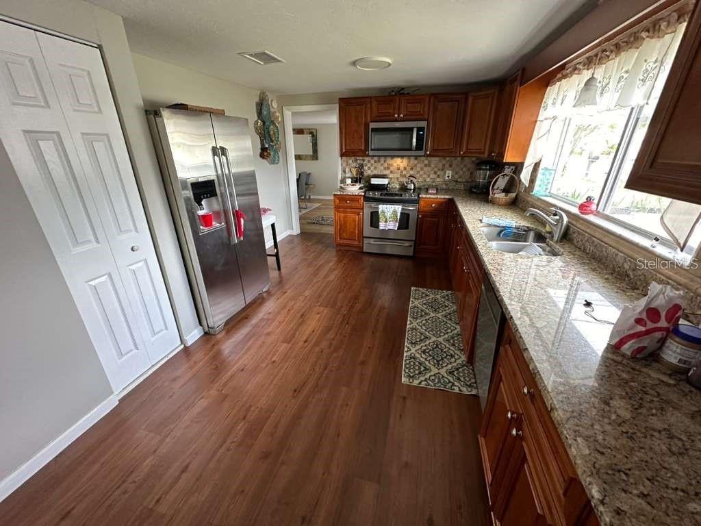 1509 Tate Street Cocoa, FL 32922 - Photo 5 of 12 a living room with stainless steel appliances furniture a fireplace and a flat screen tv