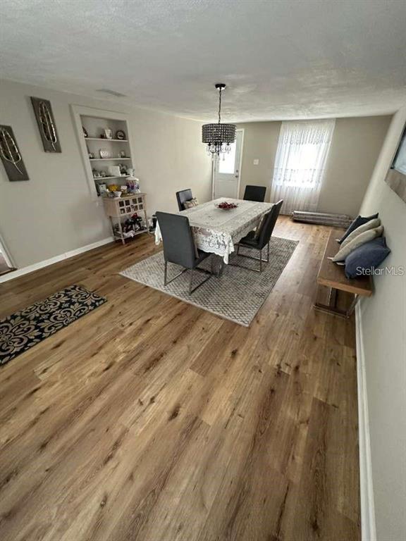 1509 Tate Street Cocoa, FL 32922 - Photo 9 of 12 a living room with furniture and a chandelier