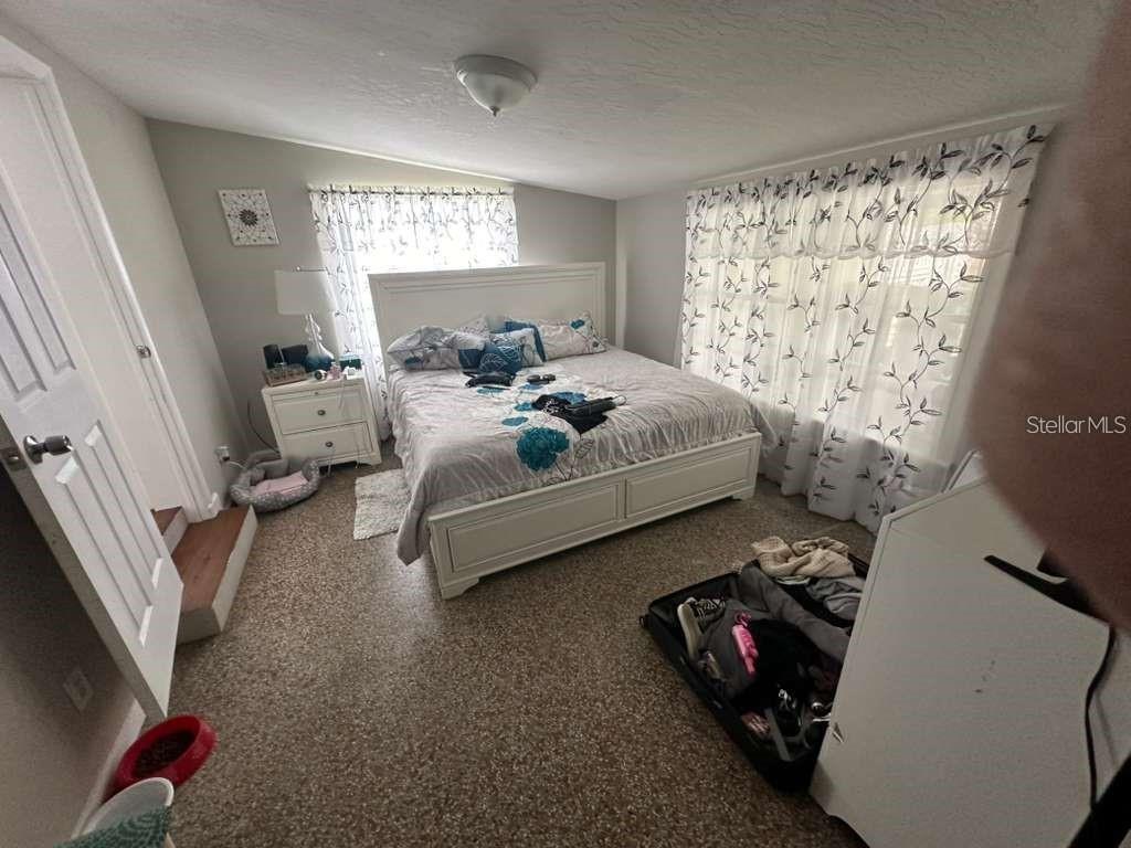 1509 Tate Street Cocoa, FL 32922 - Photo 10 of 12 a bed room with a bed and a couch