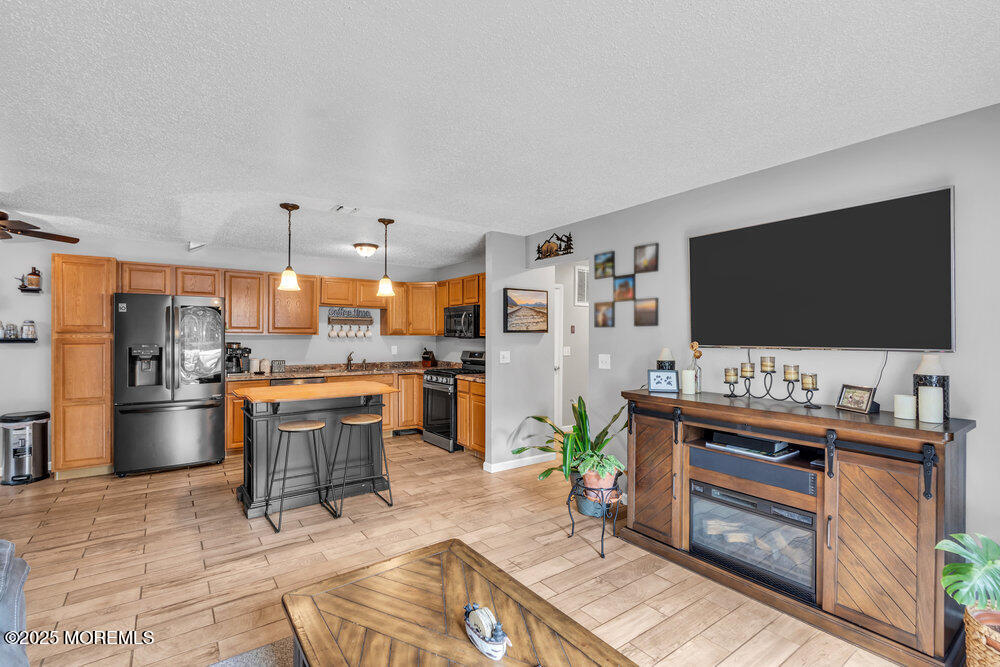1506 Jasmine Court Jackson, NJ 08527 - Photo 1 of 20 a living room with stainless steel appliances furniture and a flat screen tv