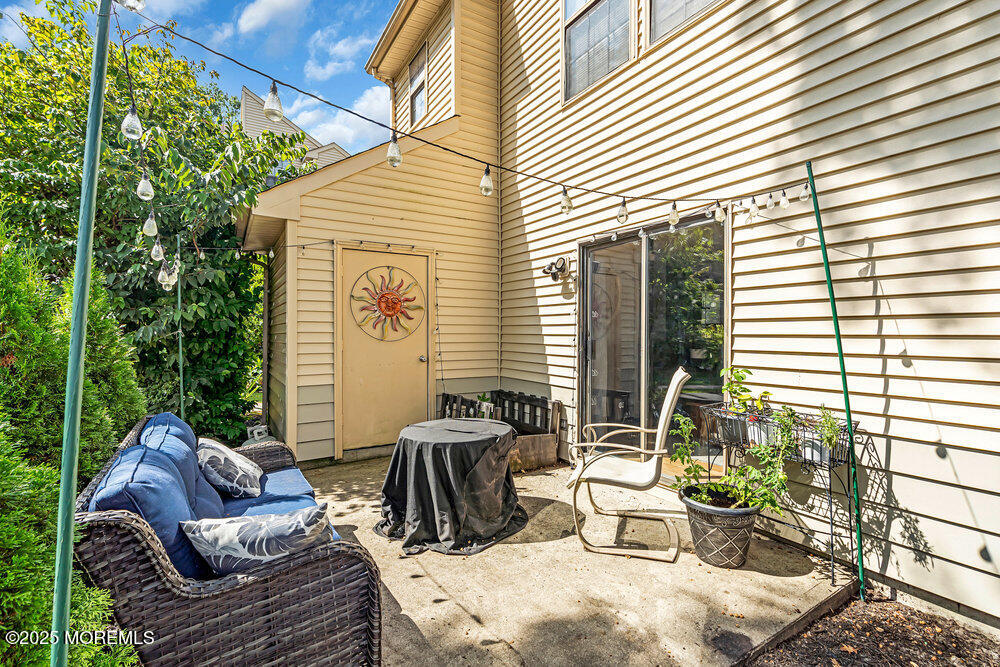 1506 Jasmine Court Jackson, NJ 08527 - Photo 18 of 20 a view of a patio with couches chairs and potted plants