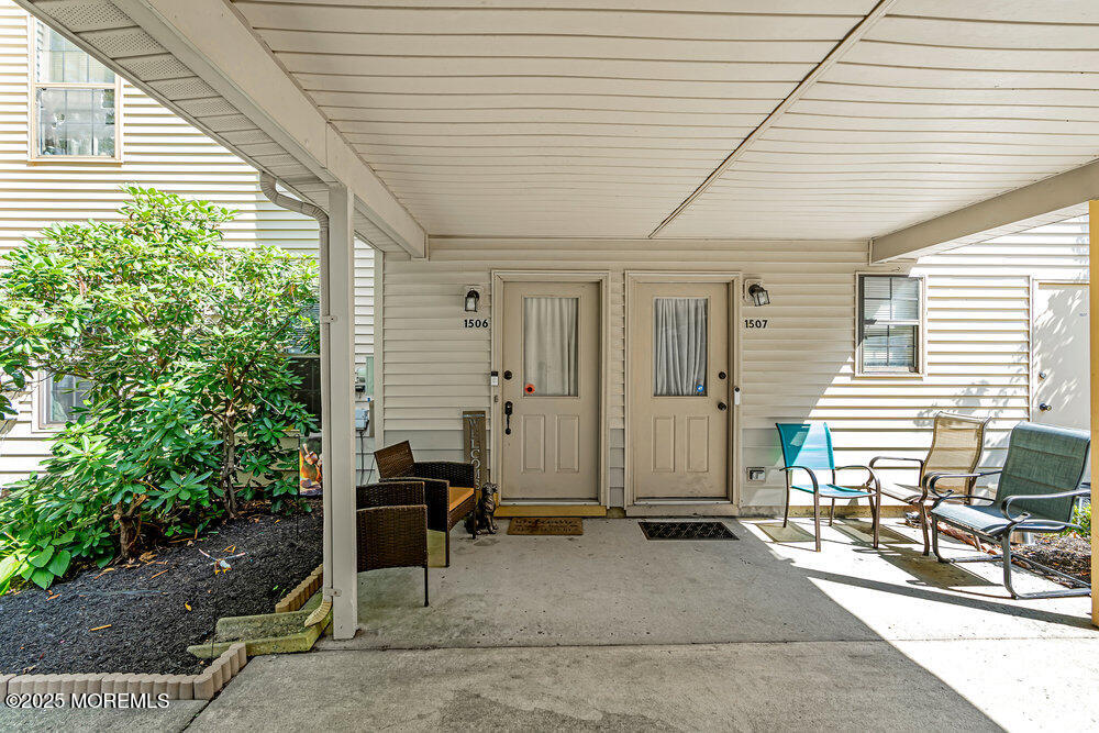 1506 Jasmine Court Jackson, NJ 08527 - Photo 2 of 20 a backyard with a table and chairs and potted plants