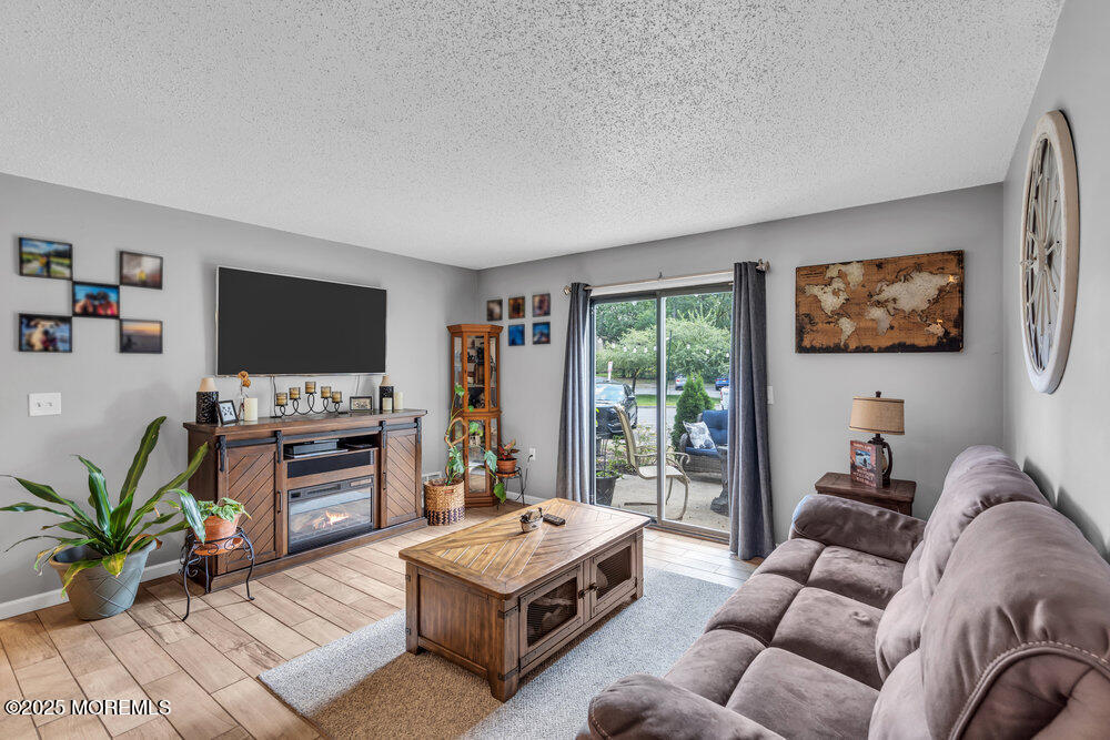 1506 Jasmine Court Jackson, NJ 08527 - Photo 4 of 20 a living room with furniture and a flat screen tv