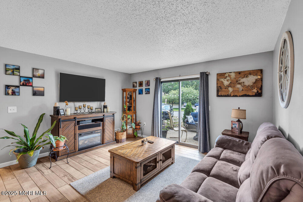 1506 Jasmine Court Jackson, NJ 08527 - Photo 5 of 20 a living room with furniture and a flat screen tv