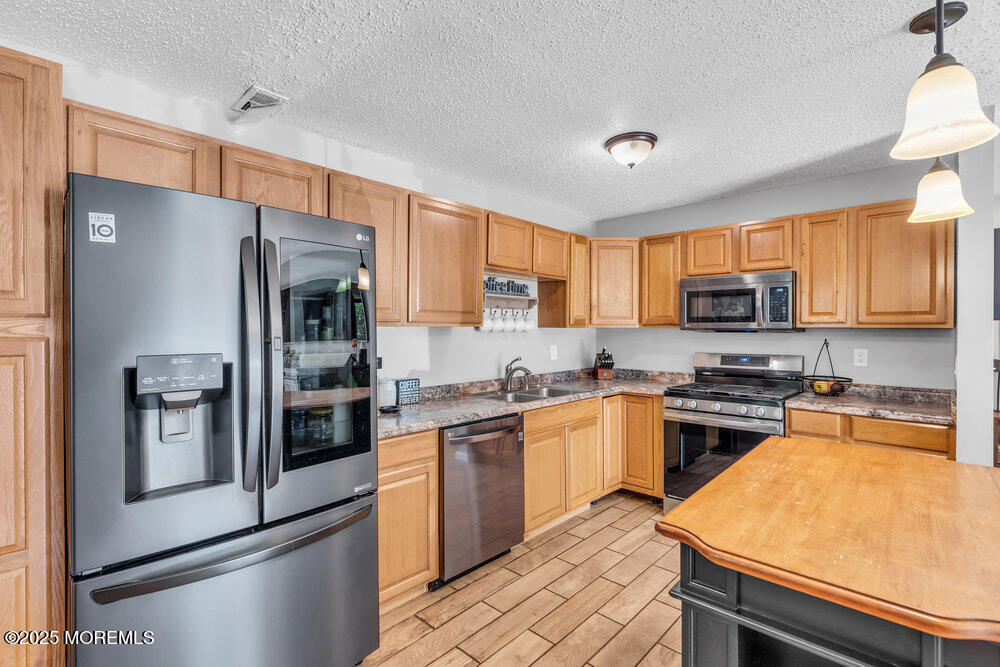 1506 Jasmine Court Jackson, NJ 08527 - Photo 7 of 20 a kitchen with stainless steel appliances granite countertop a refrigerator stove microwave and sink