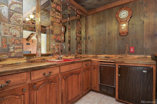 a kitchen that has a lot of cabinets in it and wooden floor