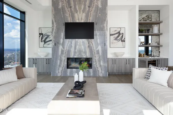a living room with furniture and a floor to ceiling window