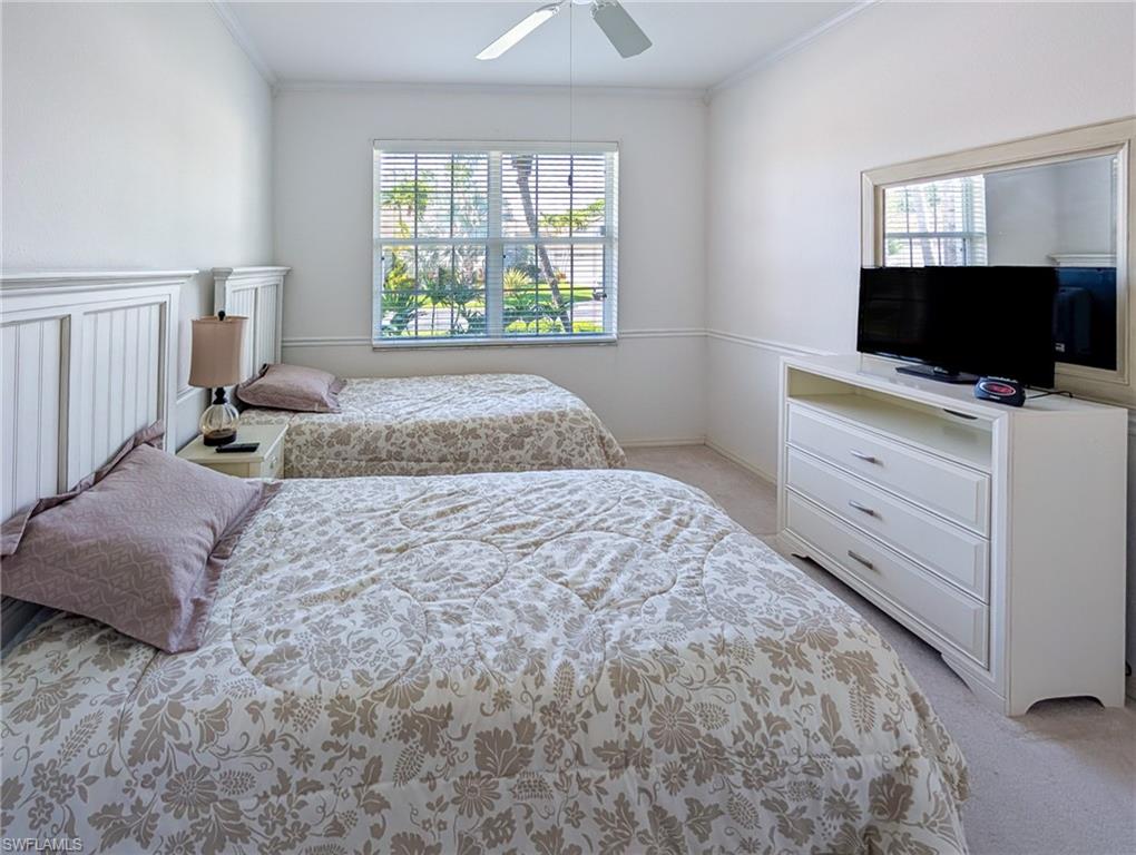 917 Fairhaven Court, Unit 29 Naples, FL 34104 - Photo 18 of 40 a bedroom with a bed and a flat screen tv