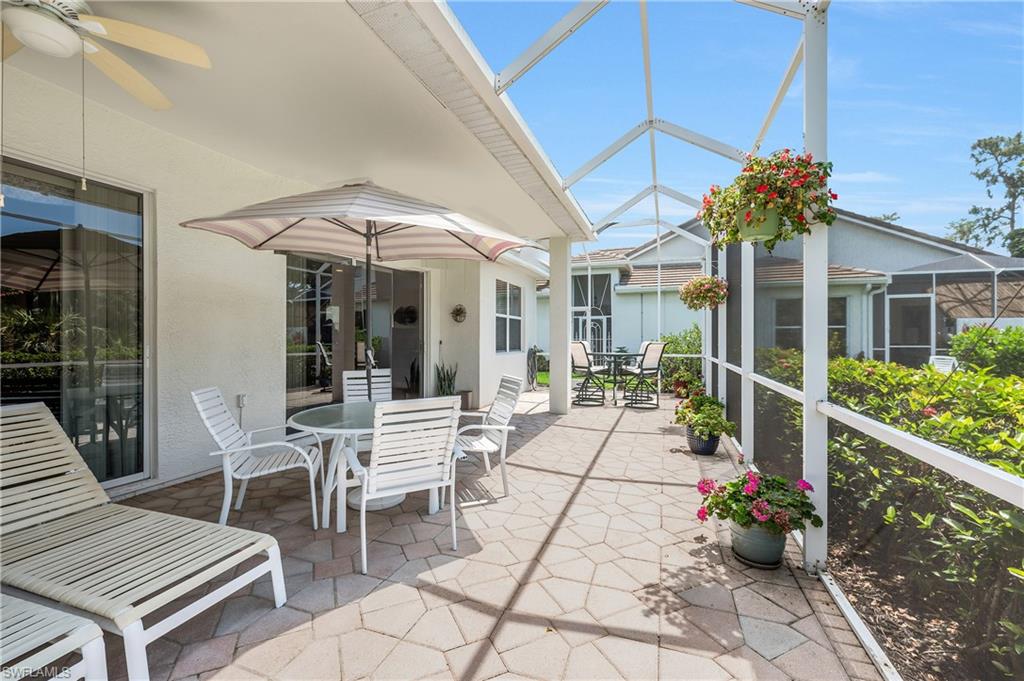 917 Fairhaven Court, Unit 29 Naples, FL 34104 - Photo 21 of 40 a view of a patio with table and chairs potted plants