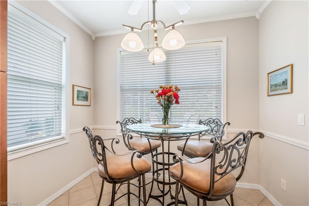 917 Fairhaven Court, Unit 29 Naples, FL 34104 - Photo 7 of 40 a view of a dining room with furniture and wooden floor