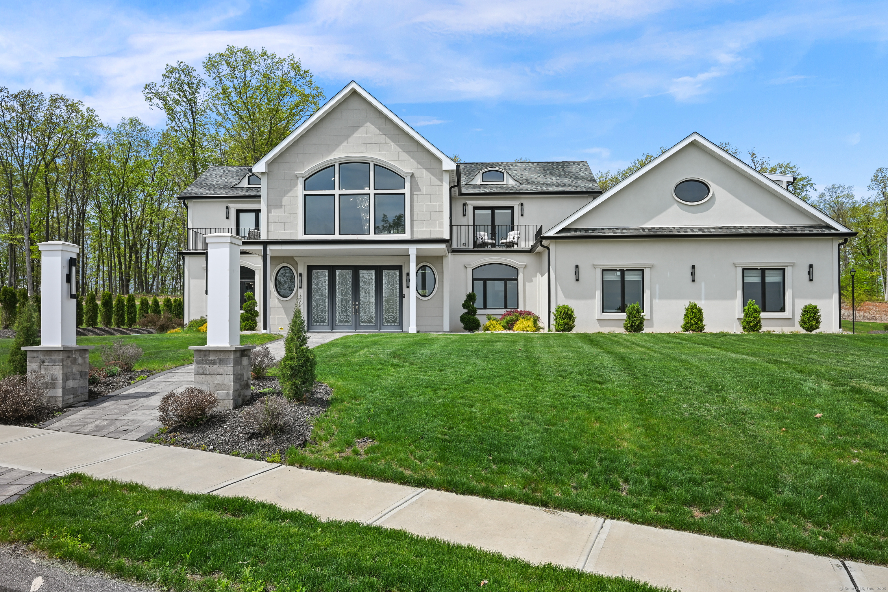 a front view of a house with a yard and porch
