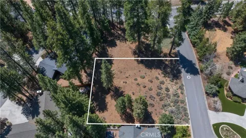 an aerial view of a house with garden space and street view