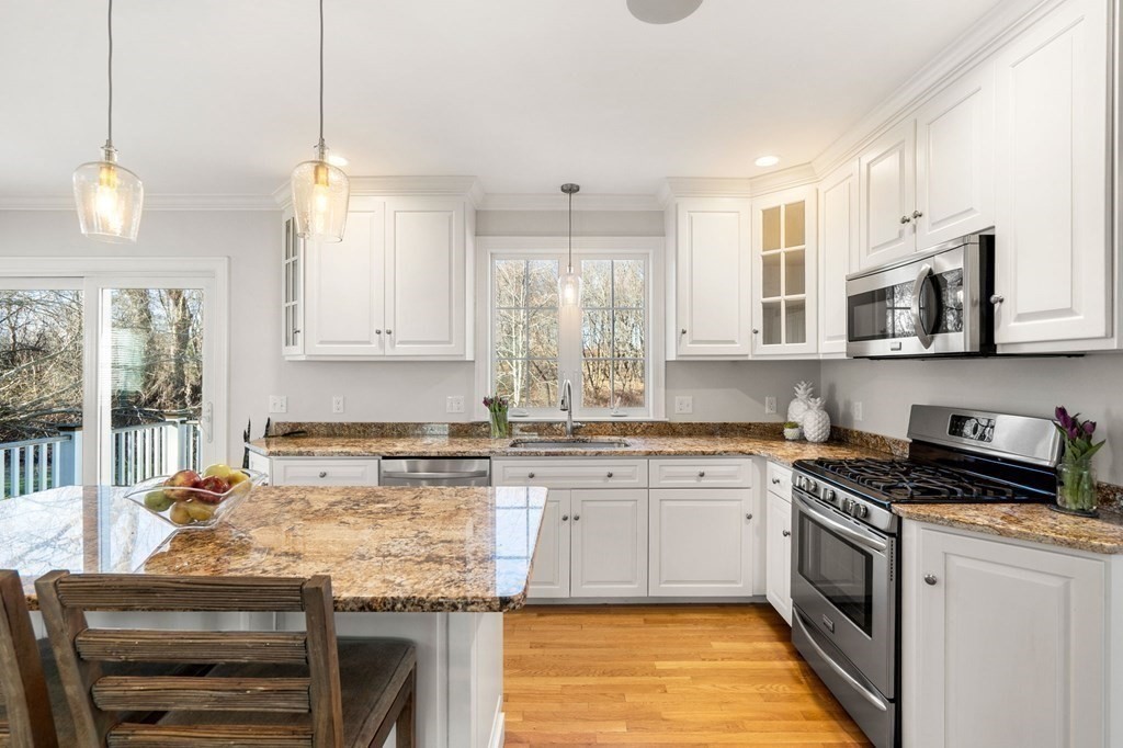 5 Abbot Court Marblehead, MA 01945 - Photo 6 of 27 a kitchen with stainless steel appliances granite countertop a stove sink microwave and cabinets