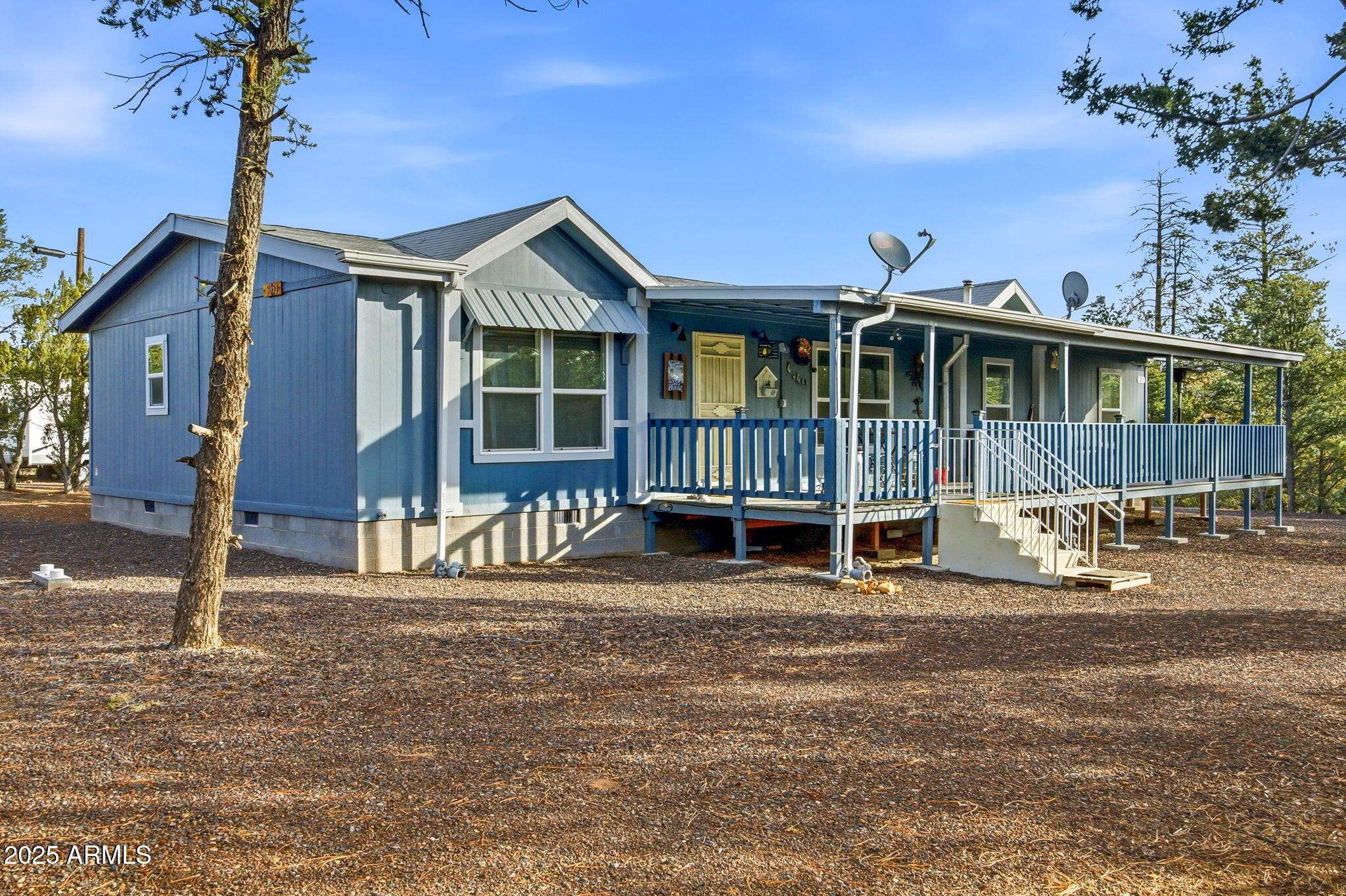 a view of a house with a yard and wooden fence