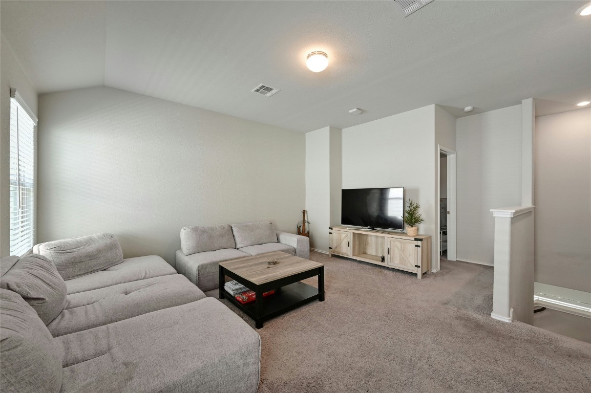 100 Comet Drive, Unit 1I Jarrell, TX 76537 - Photo 12 of 25 a living room with furniture and a flat screen tv