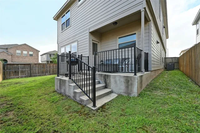 a view of a house with a yard and deck